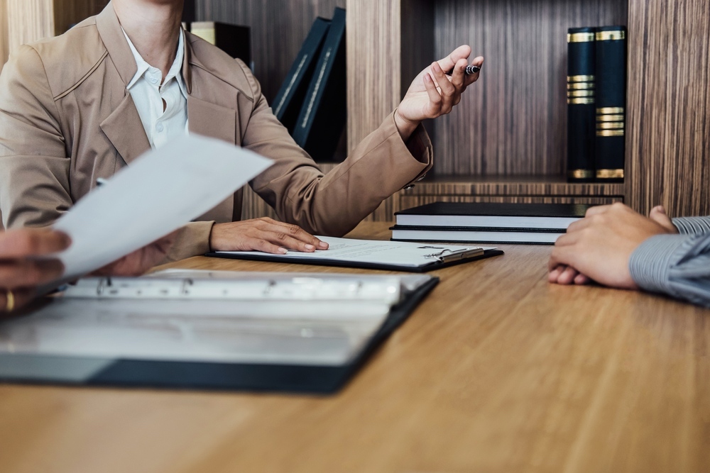 Advisory meeting across a desk with documents