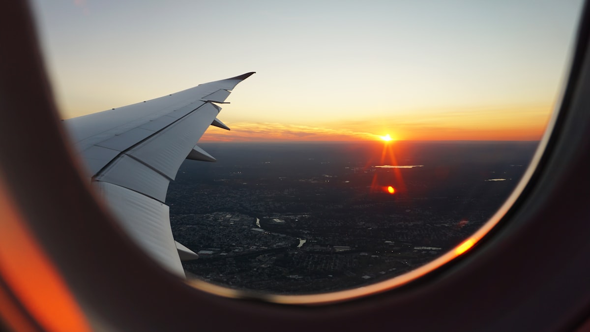 View from an airplane window at sunset